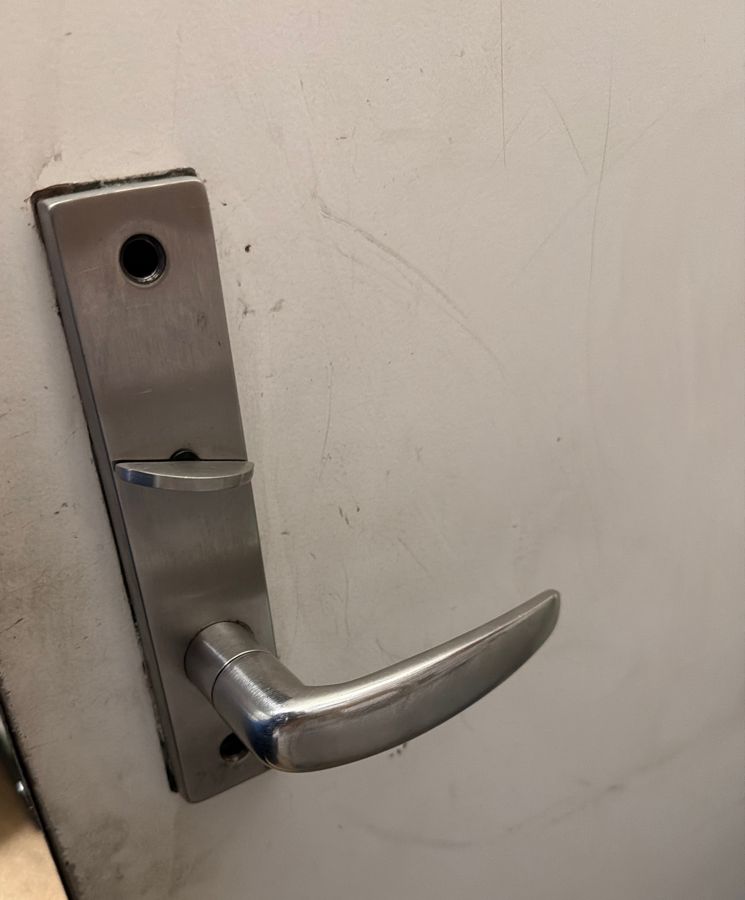 Plain lever with a thumb turn on a back-room door before the swap, Wilmington NC