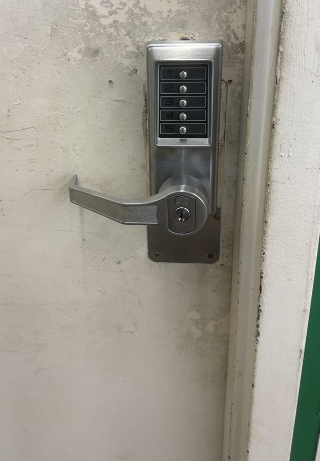 Worn pushbutton lock on a store door before replacement, Hickory NC